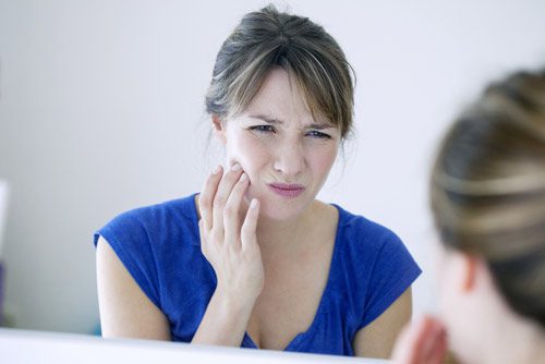 A woman experiencing a toothache